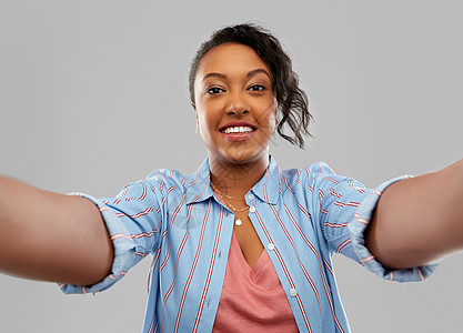 人们的快乐的非裔美国轻妇女灰色背景上自拍快乐的非裔美国妇女自拍图片