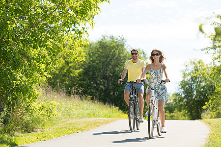 人们,休闲生活方式的快乐的轻夫妇骑自行车道路上夏天快乐的轻夫妇夏天骑自行车图片