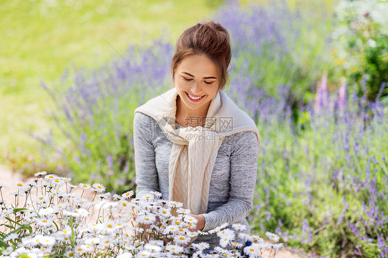 园艺人们的快乐的轻妇女与洋甘菊花夏季花园夏天花园里带花的轻女人图片