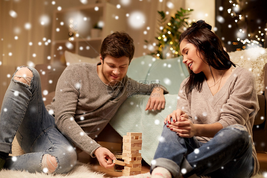 诞节,休闲人们的快乐的夫妇家里玩积木游戏雪地上快乐的夫妇家里玩积木游戏图片