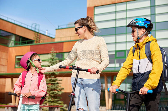 安全,学校家庭快乐的女儿,儿子母亲骑滑板车户外快乐的学校孩子妈妈骑滑板车图片