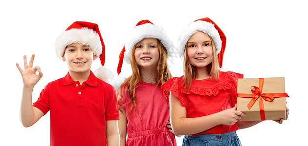 诞节,假期童的微笑的孩子诞老人帮手帽子与礼品盒好的手签白色背景孩子们戴着诞礼物的诞老人帽图片