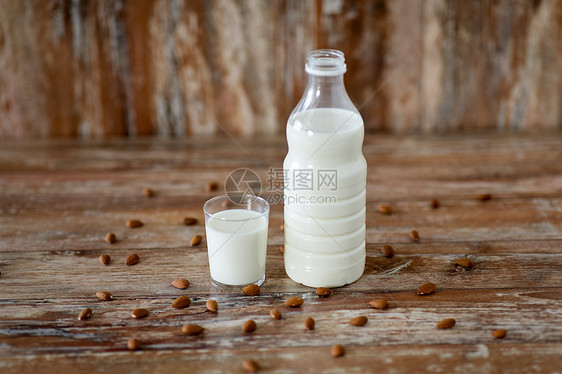 食品乳制品木制桌子上的璃瓶牛奶杏仁坚果木桌上的牛奶杏仁图片