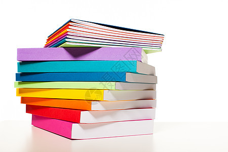 彩虹彩色书籍笔记本被概述堆放Awhite桌子上五颜六色的书籍笔记本收藏图片