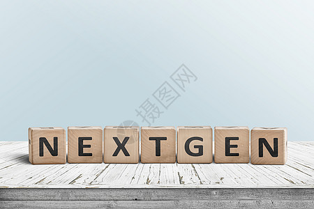 背景上青色墙壁的木板桌子上Nextgen标志图片