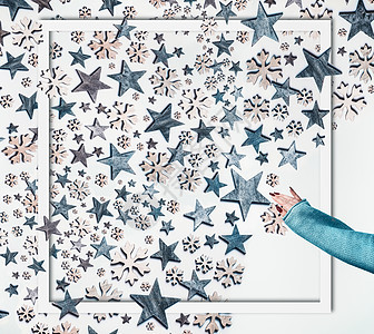 寒假的女人手针毛衣,蓝色的星星装饰雪花图案成的框架白色的背景创意诞布局顶部视图平躺图片