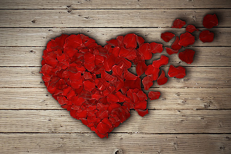 红色玫瑰花瓣排列成破碎的心木桌上心碎分手分离离婚图标医学心血管健康的象征图片
