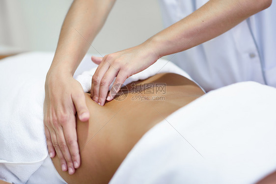 女患者正接受专业骨病治疗师的治疗水疗沙龙接受腹部按摩的女人图片