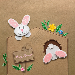 创意复活节照片的兔子个洞的纸制成棕色背景图片