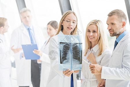 群医生讨论X光群轻的医生诊所医院里看并讨论X光图片