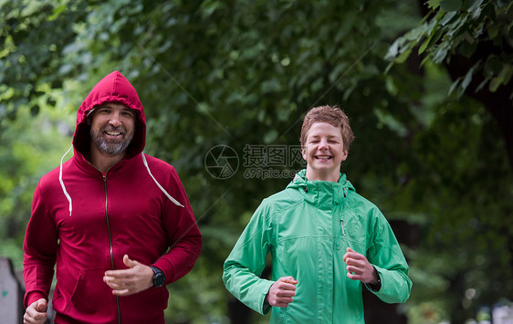 晨练慢跑夫妇健康慢跑夫妇城市公园跑步,跑步队参加晨训图片