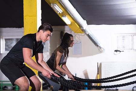 运动夫妇战斗绳交叉健身运动轻的健康运动夫妇功能训练健身房锻炼,战斗绳交叉健身运动图片