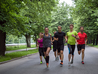 跑步队参加上午的训练群健康的人城市公园慢跑,跑步队参加晨训图片