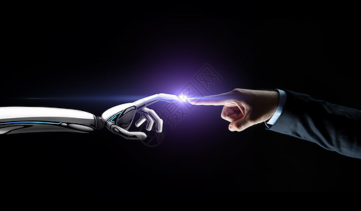 人工智能,未来技术通信机器人人手连接手指黑色背景与耀斑机器人人手连接手指图片