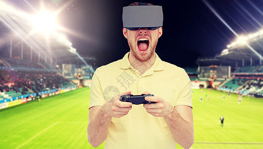 三维技术,虚拟现实,体育,娱乐活动人的人虚拟现实耳机3D眼镜玩游戏控制器游戏垫足球场背景人虚拟现实耳机足球场上背景图片
