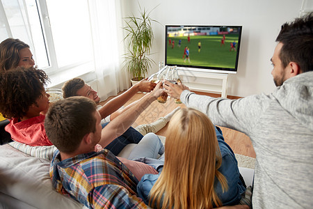 足球,休闲人的快乐的朋友叮当响啤酒瓶,家里看电视上的足球比赛朋友们喝啤酒看足球比赛图片