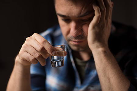 酒精成瘾人们的接近男酒精饮用伏特加夜间拍摄晚上靠近男人喝酒伏特加晚上靠近男人喝酒伏特加图片