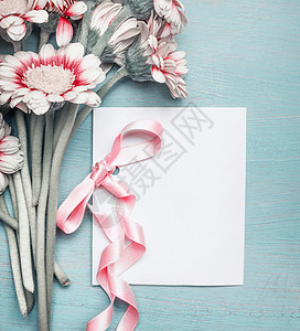 绿松石蓝色破旧别致的背景上特写漂亮的花,并为母亲节婚礼生日快乐活动模拟带粉红色丝带的贺卡图片