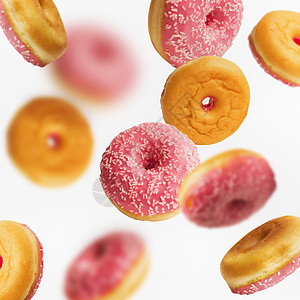 坠落飞行粉红色釉甜甜圈与洒白色背景,创造的布局图案图片
