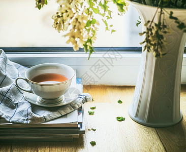 窗户上的杯茶,还花瓶花夏天的静物舒适的家庭场景图片