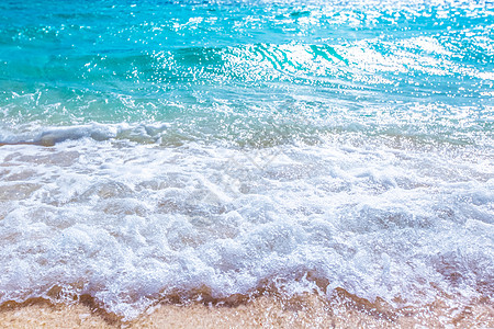 沙滩上海浪美丽的自然背景,海边度假的理念沙滩上的海浪图片