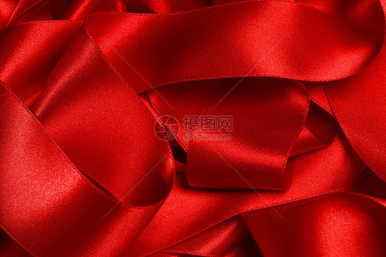 堆红色丝绸丝带,用于节日装饰,背景红色丝带背景图片
