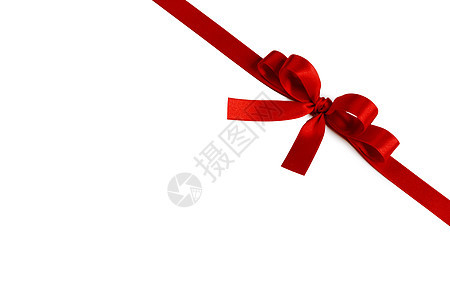 闪亮的红色缎带蝴蝶结隔离白色背景上节日礼物的闪亮的红色缎带蝴蝶结图片