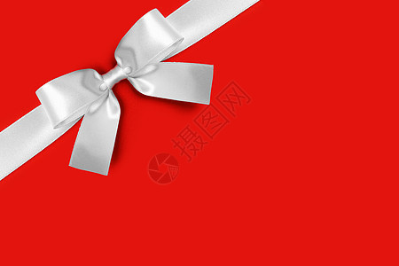 闪亮的白色缎带红色背景的蝴蝶结节日礼物的闪亮的白色缎带蝴蝶结背景图片