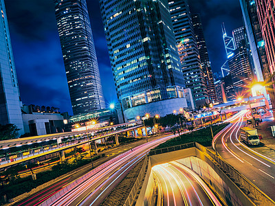 晚上的街道交通写字楼摩天大楼高速公路上繁忙的交通,车辆模糊,小径轻盈中国香港香港夜间的街道交通图片