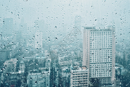 雨水滴窗户璃纹理上,背景摩天大楼雨点落窗户上图片