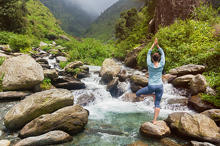 女人哈塔瑜伽平衡瑜伽,阿莎娜,vrikshasana树姿势瀑布户外瑜伽中的女人瀑布户外摆姿势图片