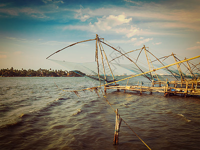 复古效果过滤了潮人风格的形象,科奇中国鱼网日落科钦堡,科奇,喀拉拉邦,印度日落时的中国渔网科奇,印度图片