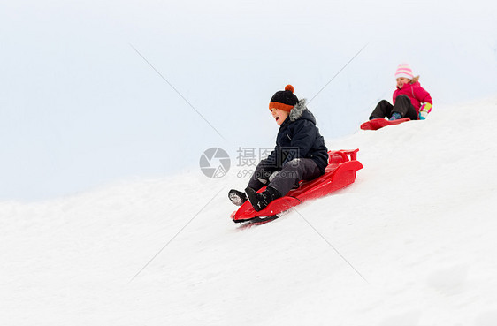 童,雪橇季节快乐的孩子们冬天乘雪橇滑下雪山快乐的孩子们冬天乘雪橇下山图片