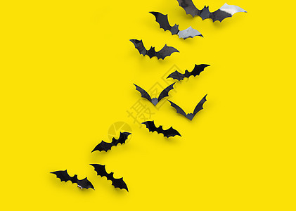 万节装饰品许多黑色纸蝠黄色背景黄色背景的黑色万节蝙蝠图片