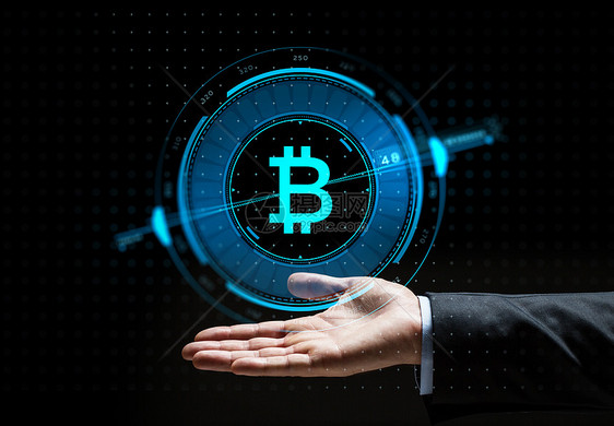 加密货币金融技术商业Buisnessman手与虚拟比特币符号全息图黑色背景上布尼斯曼手与比特币全息图图片