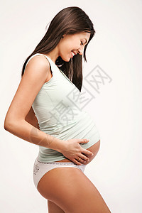 怀孕母亲的肖像,白色的背景图片