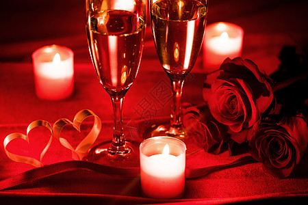 情人节庆祝活动,杯香槟,蜡烛,玫瑰红丝上的心图片