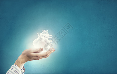 心脏护理紧紧握住人类的手,握住人类的心背景图片