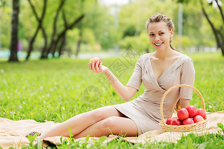 带苹果的女孩夏天公园里带着苹果的轻漂亮女人背景图片