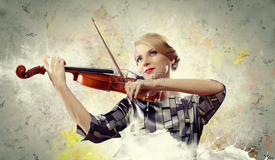 漂亮的女人拉小提琴美丽的女小提琴手飞溅的背景下演奏的形象图片