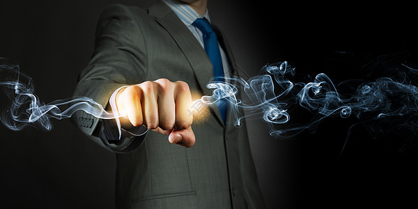 手中的力量商人握着火焰拳头权力控制图片素材