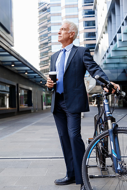 成功的商人骑自行车成功的商人穿着西装骑自行车咖啡图片