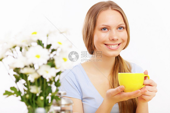 美丽的轻女子杯子里喝茶图片