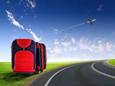 蓝色天空中的红色手提箱飞机图片