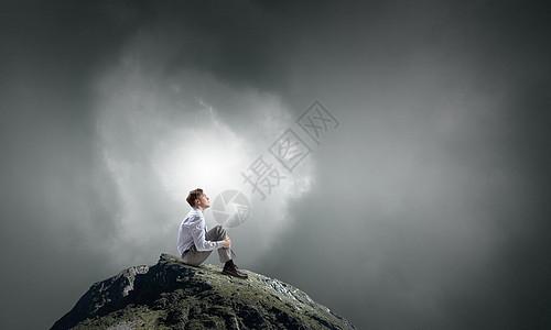 孤立地寻找灵感轻的思想的商人独自坐山顶上图片