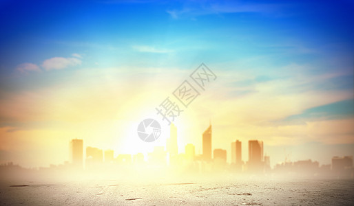 城市上空的日出太阳升城镇上方的形象图片