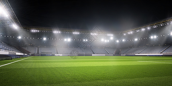 灯光下的足球场空足球绿场的背景图像图片