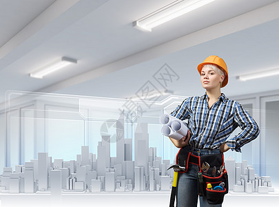 女工程师轻的女人戴着安全帽,手里着建筑项目图片