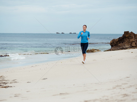 运动的轻女人海边跑步图片