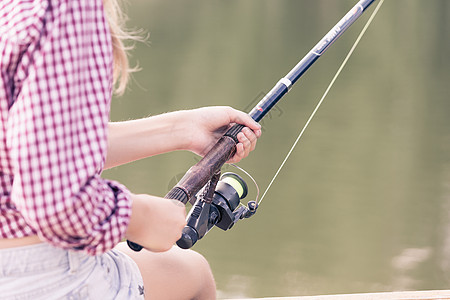 父子钓鱼会钓大鱼的靠近坐银行钓鱼的女孩背景